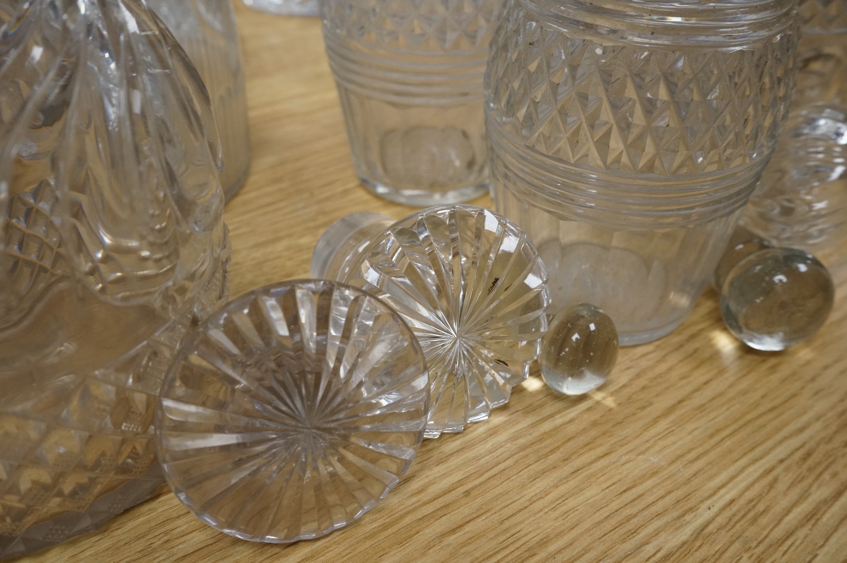 A collection of Regency and later glass decanters and stoppers, tallest 31cm